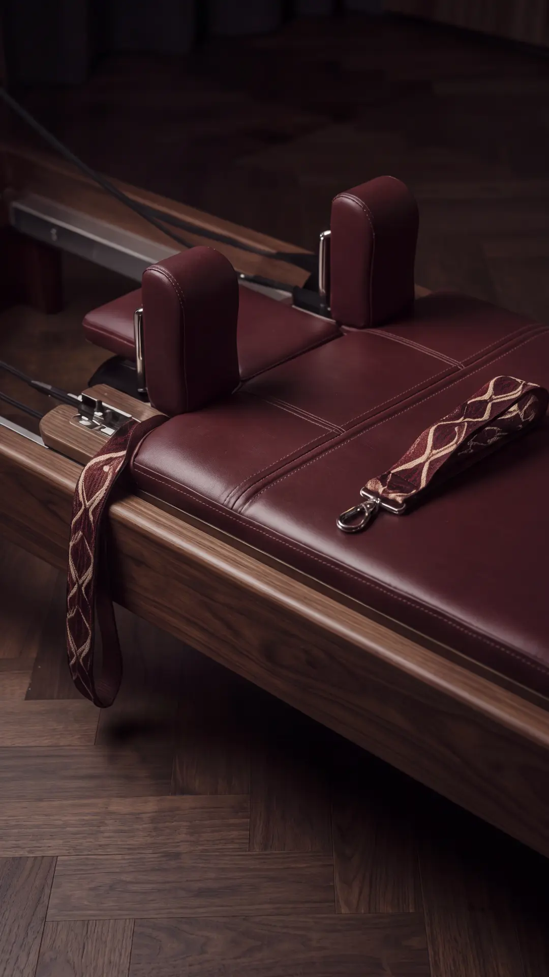 Pilates Club concept — burgundy reformer upholstery and chrome details