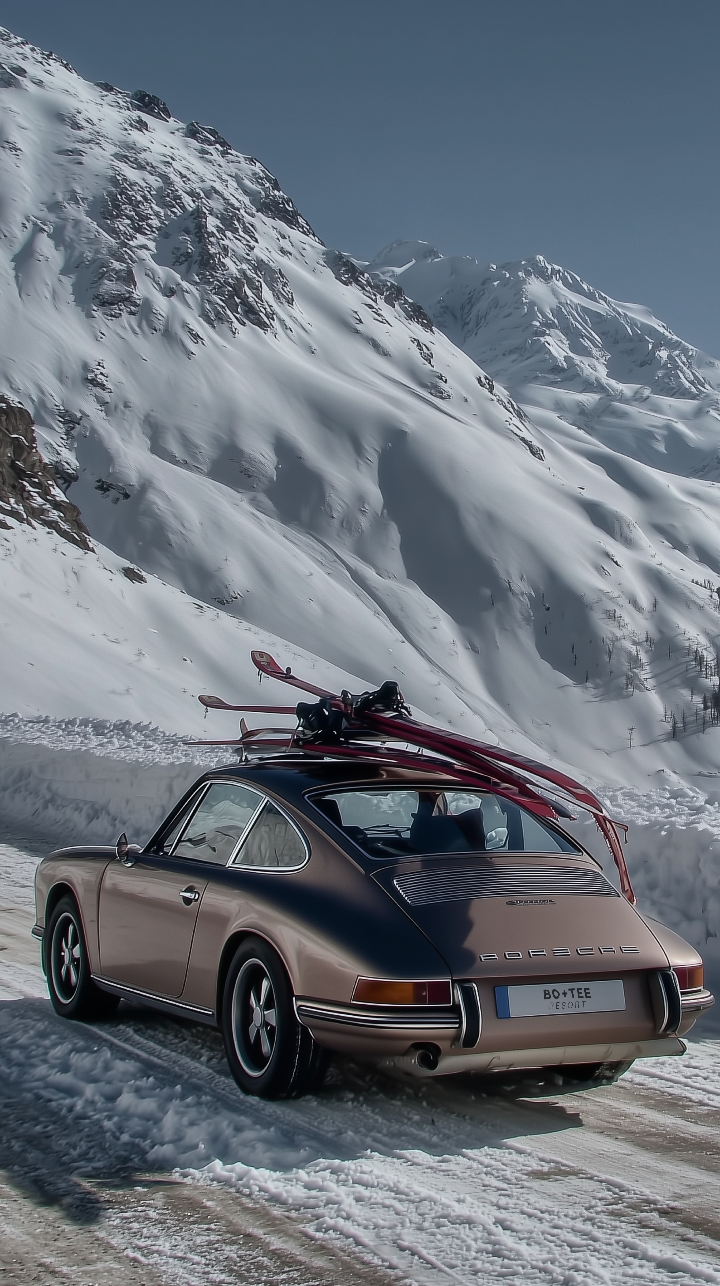 Bo+Tee Winter campaign: vintage car carrying branded skis beneath snowy mountains