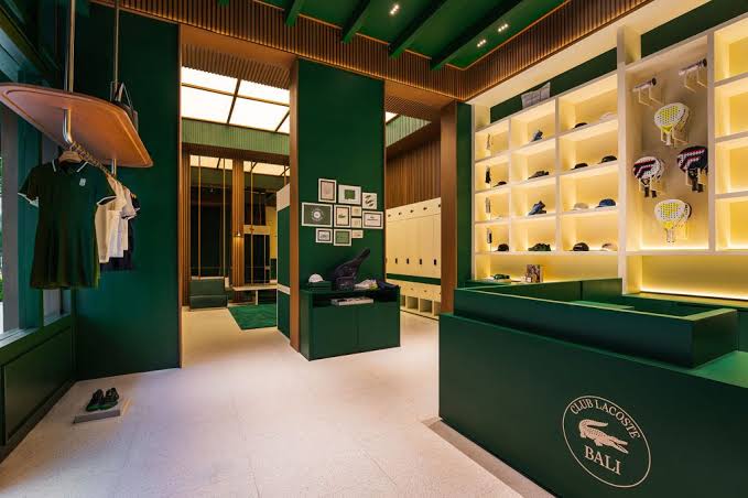 The finished retail space with green counters and lit shelving